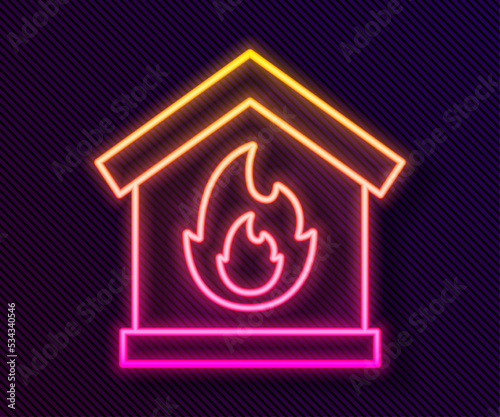 Glowing neon line Fire in burning house icon isolated on black background. Vector