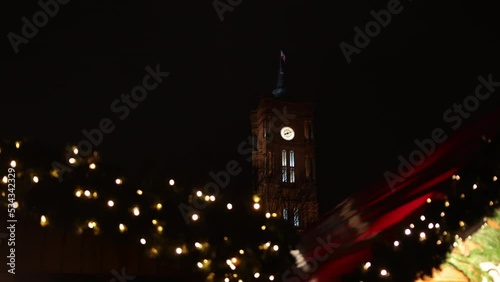 In Berlin's Mitte district, Red Town Hall Rotes Rathaus lights up during Christmas holidays in winter at night, Christmas tree in foreground, famous Rotes Rathaus, town hall photo
