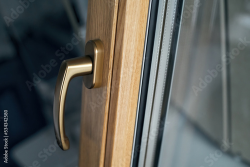 stylish handle on the window frame in gold color.