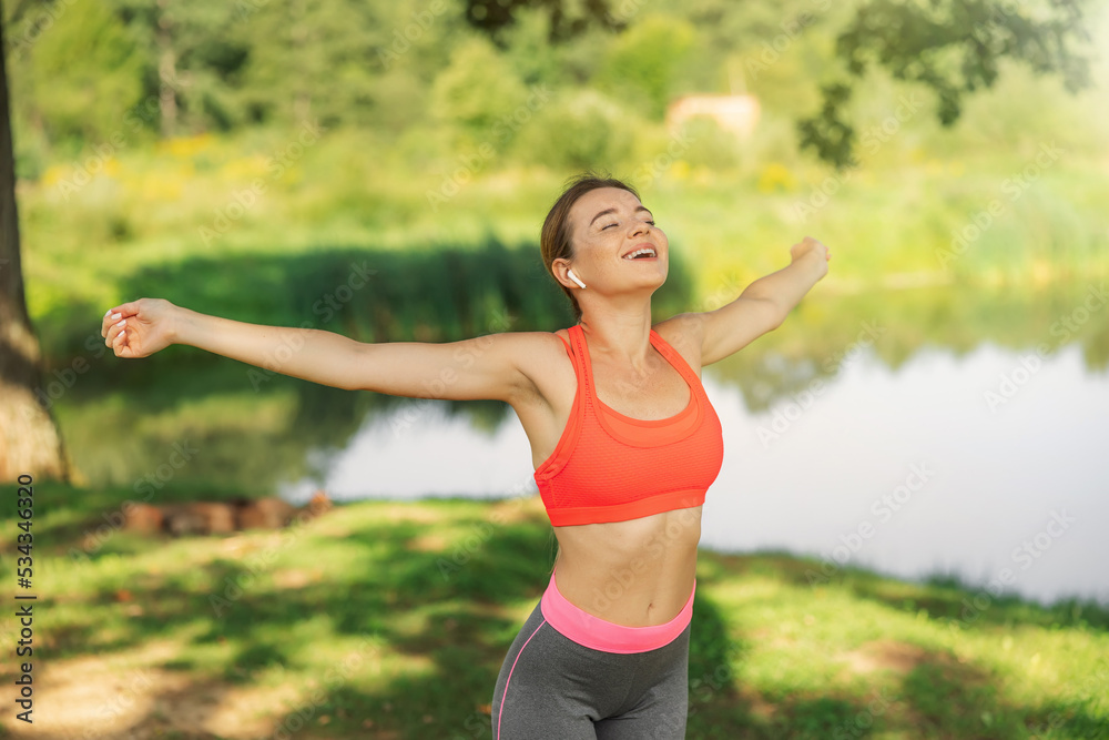 Attractive blonde woman practicing yoga in a park with closed eyes Attractive blonde woman practicing yoga in a park with closed eyes