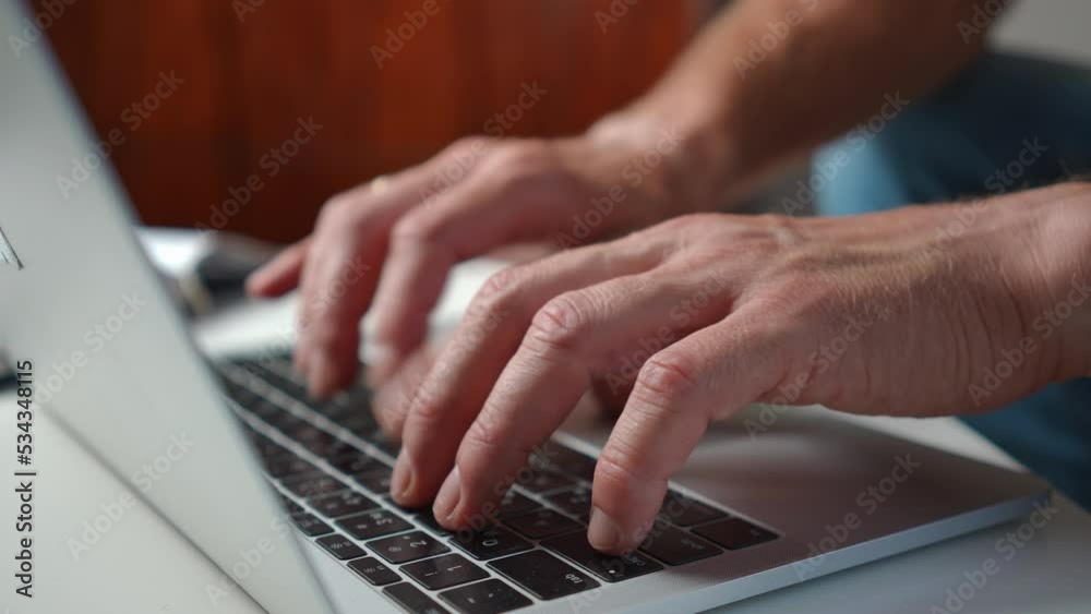 Close-up male hands typing fast on laptop keyboard indoors. Unrecognizable Caucasian adult guy messaging online surfing Internet sitting at home. Modern technologies and convenience concept Close-up male hands typing fast on laptop keyboard indoors. Unrecognizable Caucasian adult guy messaging online surfing Internet sitting at home. Modern technologies and convenience concept