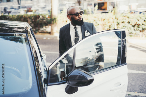 Εκτύπωση καμβά A portrait of a tough bald African businessman with a beautiful black beard, in