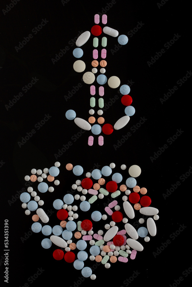 money symbol made with colored pills on a black background money symbol made with colored pills on a black background