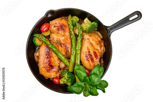 Roasted chicken breasts with vegetables in frying pan. Healthy food, isolated on white background. High resolution image.