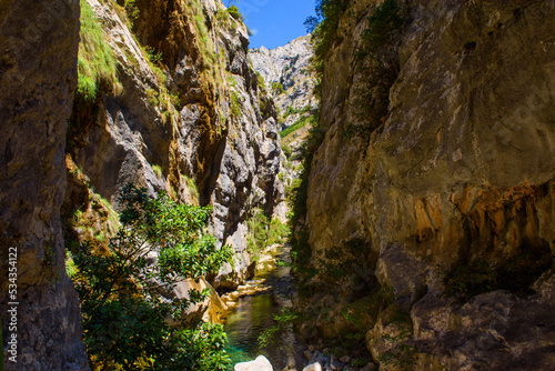 Cares river gorge route. Hiking trail in Picos de Europa National Park  Spain. Mountain path between impressive cliffs