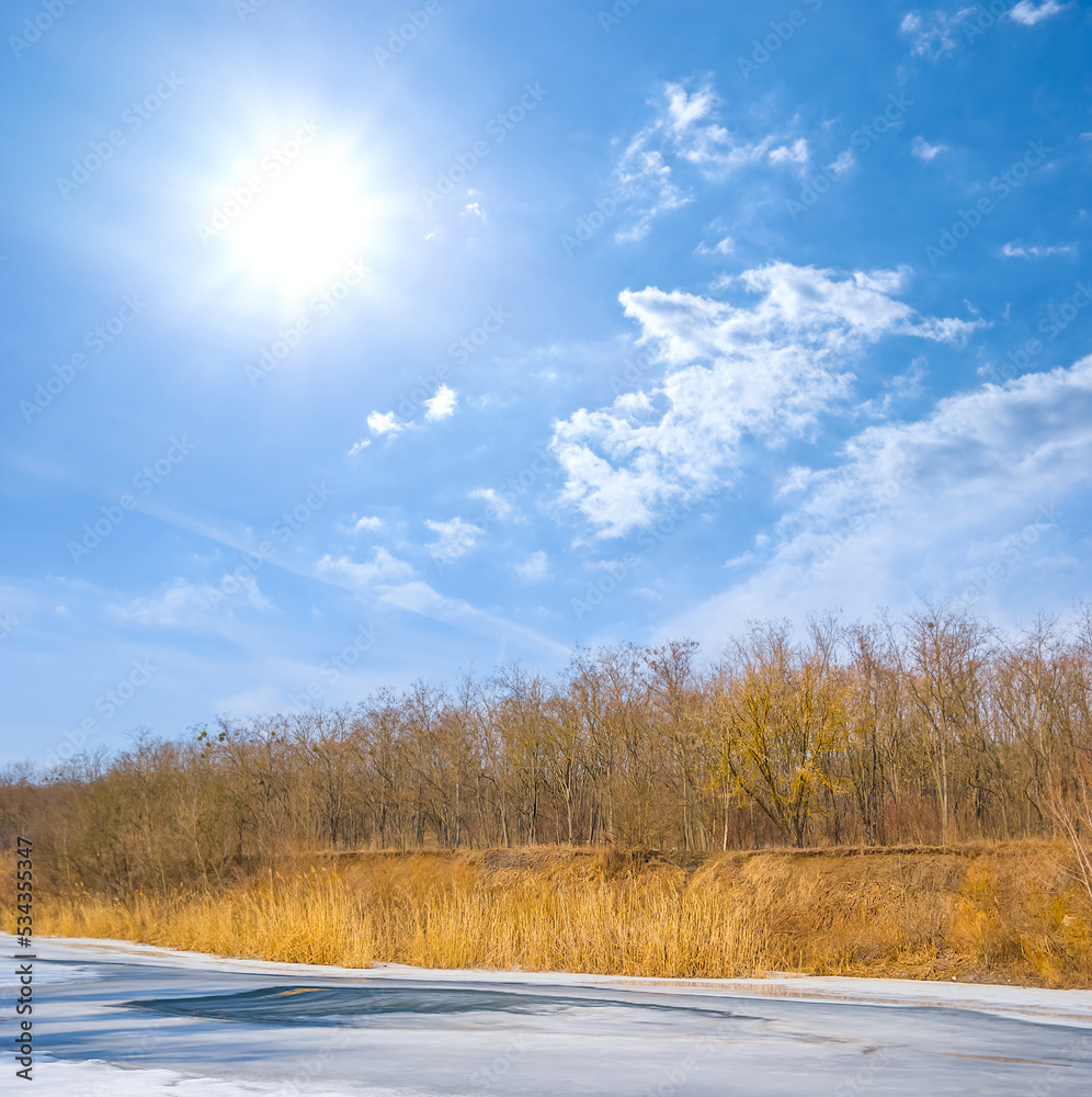 frozen river at the cold sunny day, winter outdoor scene