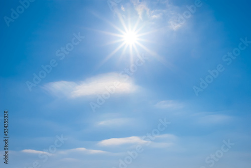 sparkle sun on blue cloudy sky, natural outdoor background
