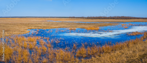 small blue lake among prairie, seasonal natural landscape
