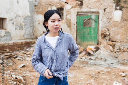 Young Asian girl is standing among the ruins photo