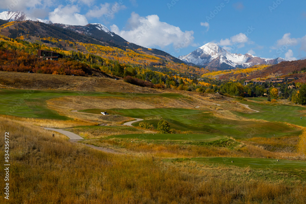 Snowmass golf course in autumn with snow-covered Mt. Daly in the background.