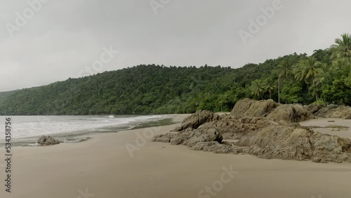 rocks and beach at etty bay, renown southern cassowary habitat, in the wet tropics of north queensland, australia photo