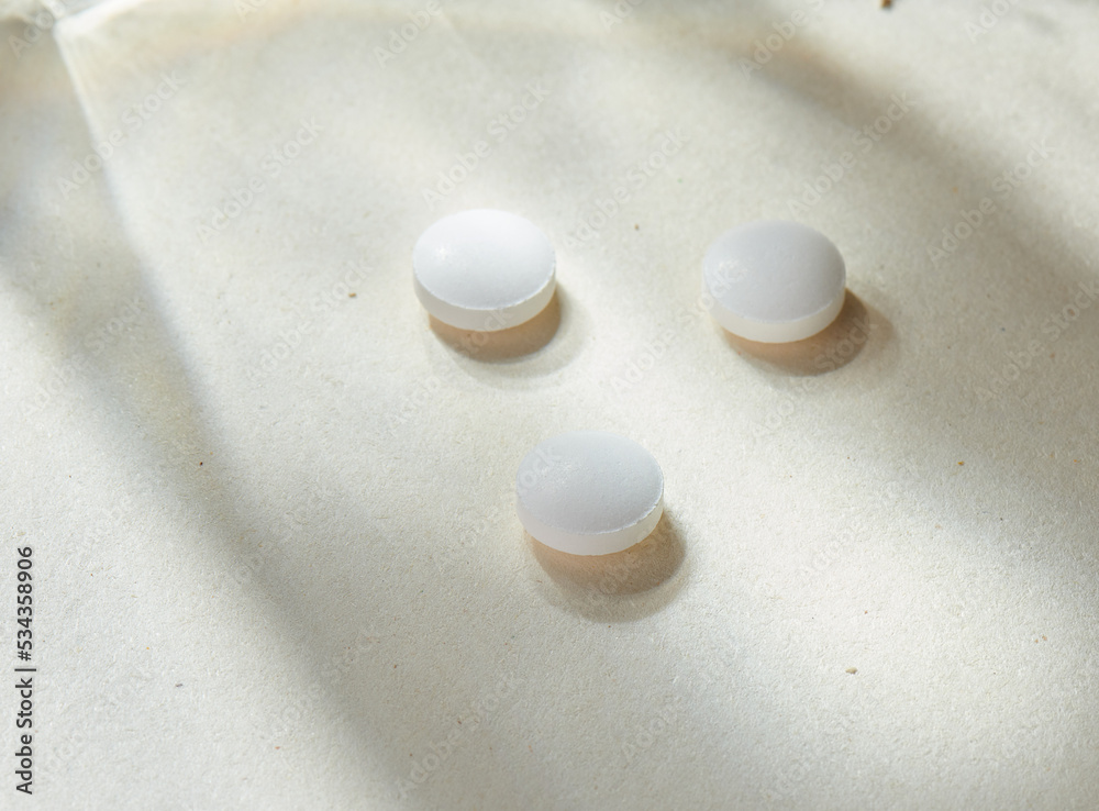 Medicine pills with natural beige background and props. Antipyretic, antibiotic, aspirin, antiviral or vitamine tabs. Health care and medicine concept... Check my profile for more!