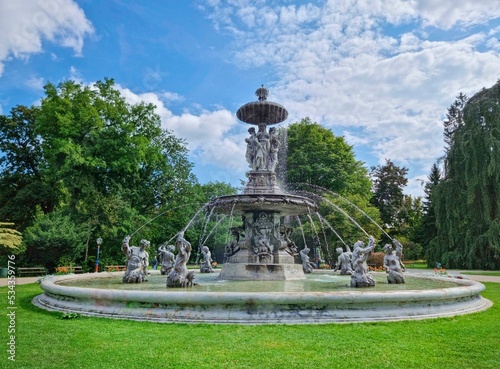 Beautiful fountain in the city park Stadtpark, a green island in the middle of the city center of Graz, Styria region, Austria. Selective focus photo