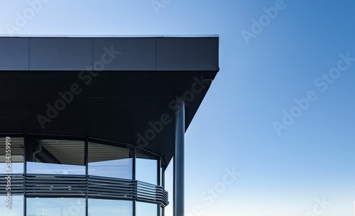 Modern building with glass windows against a blue sky photo