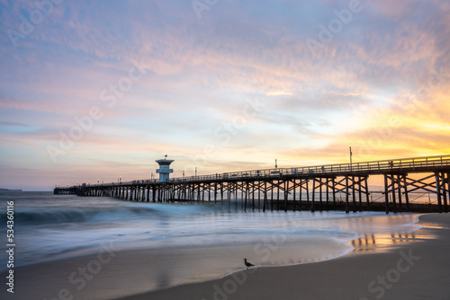 Vibrant Sunset burns over Seal Beach Pier Long Exposure Wave Photography 