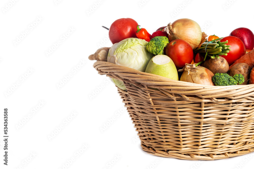Assorted organic vegetables and fruits in wicker basket isolated on white background. Space for text. Assorted organic vegetables and fruits in wicker basket isolated on white background. Space for text.