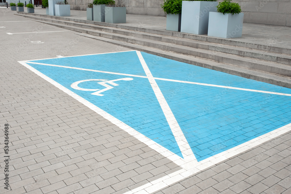 Car parking lot with wheelchair symbol outdoors