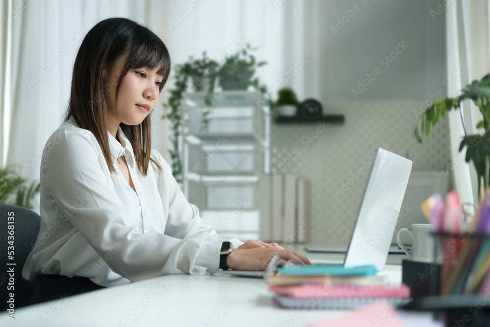 Pretty young creative woman working online, searching online information on laptop. Pretty young creative woman working online, searching online information on laptop.