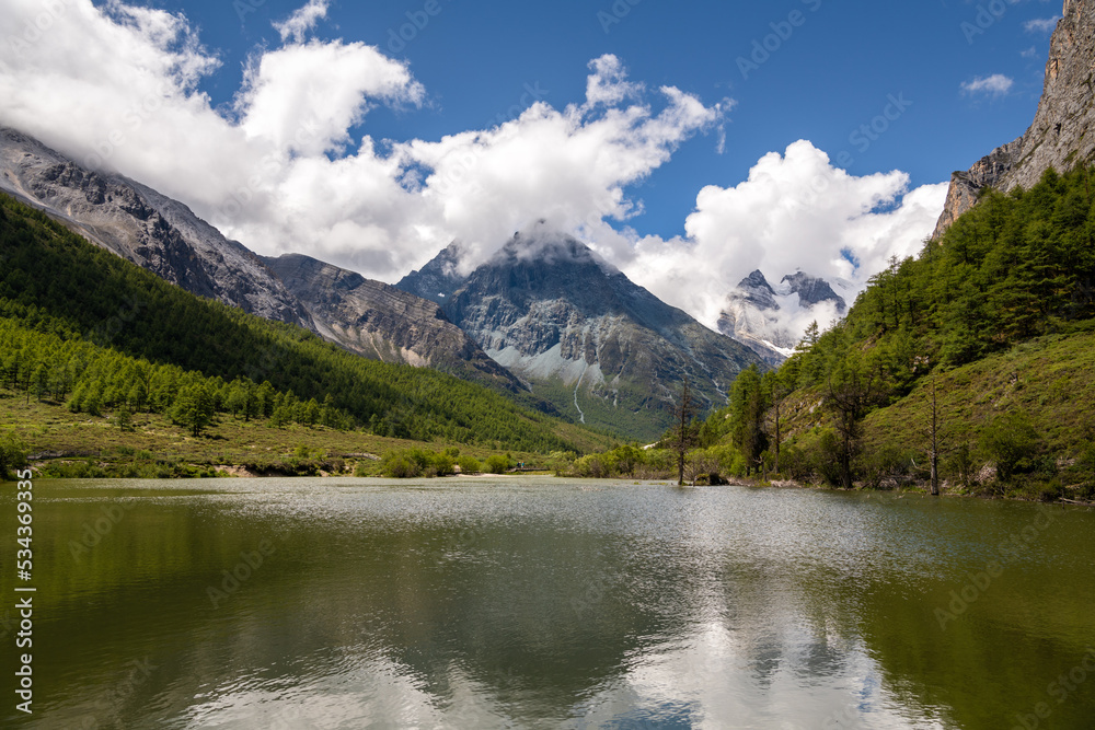 Beautiful Summer scene in Daocheng Yading National park, Sichuan, China, lake, sky reflection, copy space for text, background, wallpaper