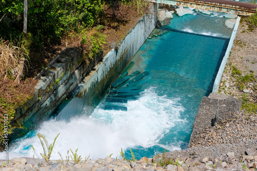 Unusual turquoise polluted water flowing in river waterway at Panguna Mine in Bougainville  Papua New Guinea