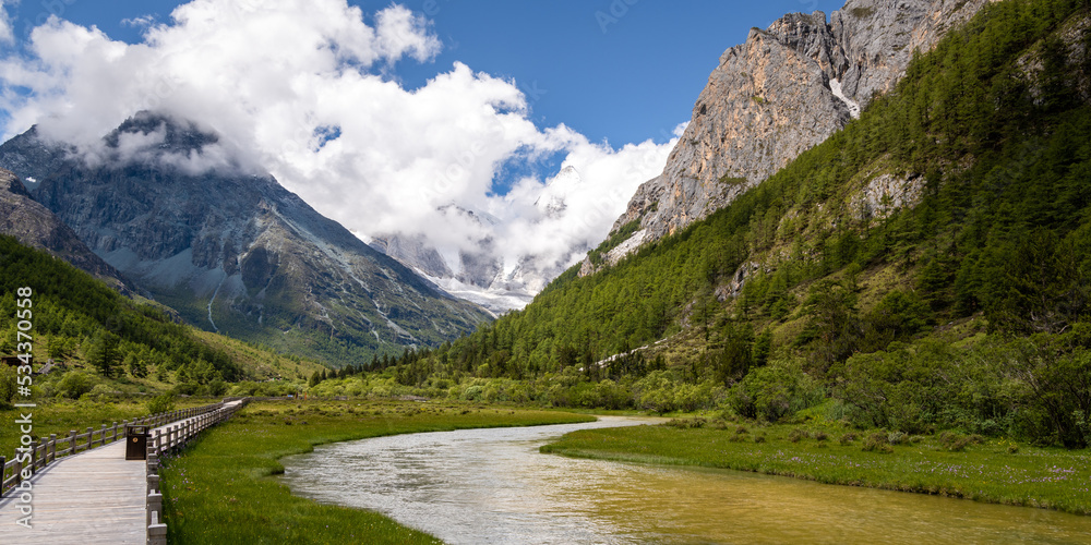 Daocheng Yading scenery- S shape river and mountains covered with clouds. The scenic spot is located in Daocheng, Sichuan, China. Panorama