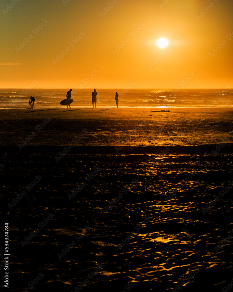 surfing on the ocean at sunset surfing on the ocean at sunset