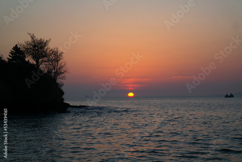 red sun setting over the horizon