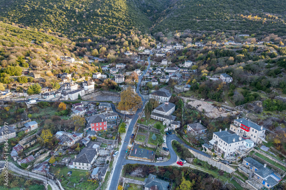 aerial view of   Ano Pedina village a misty  autumn morning with its architectural traditional old stone  buildings located on Tymfi mount, Zagori, Epirus, Greece,