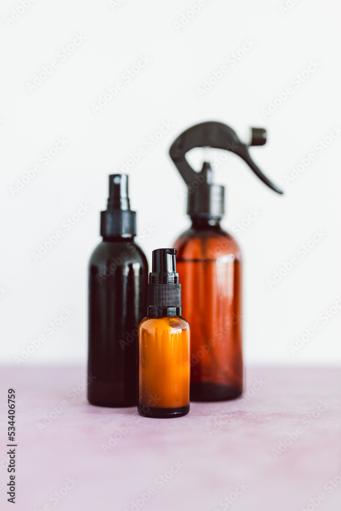 apothecary skincare bottles and scent spray on pink background, organic ingredients in skincare
