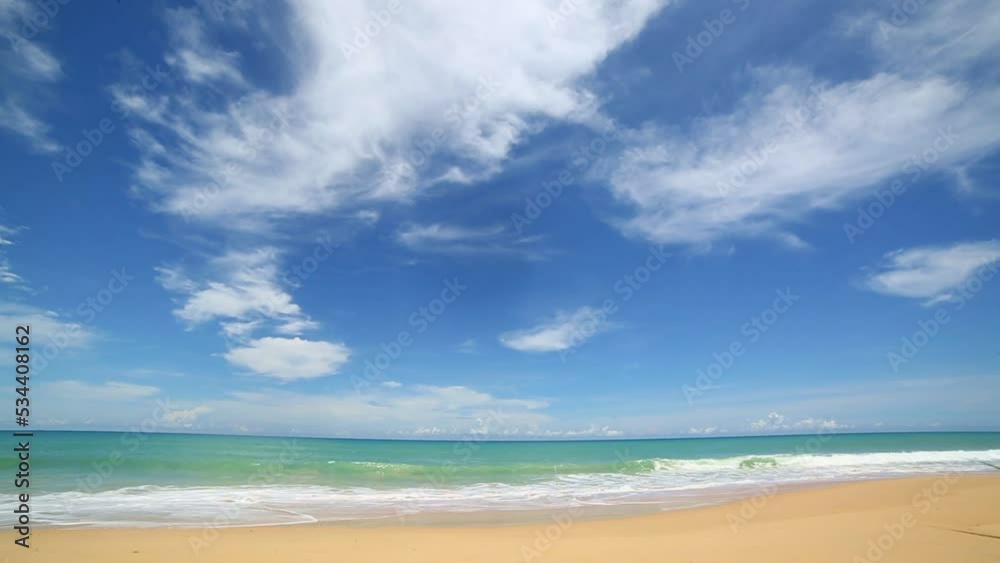 scenery smooth waves from green sea hit on the white long beach..beautiful nature on the beach..white cloud in blue sky background. scenery smooth waves from green sea hit on the white long beach..beautiful nature on the beach..white cloud in blue sky background.