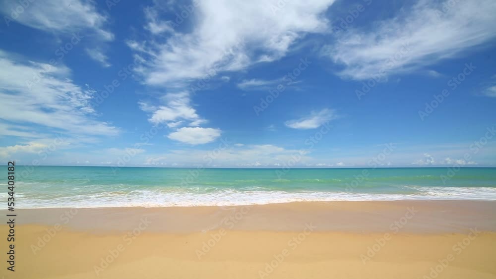 scenery smooth waves from green sea hit on the white long beach..beautiful nature on the beach..white cloud in blue sky background. scenery smooth waves from green sea hit on the white long beach..beautiful nature on the beach..white cloud in blue sky background.