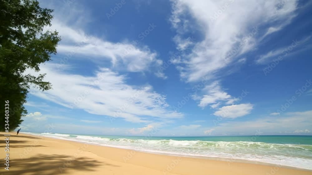 scenery smooth waves from green sea hit on the white long beach..beautiful nature on the beach..white cloud in blue sky background. scenery smooth waves from green sea hit on the white long beach..beautiful nature on the beach..white cloud in blue sky background.
