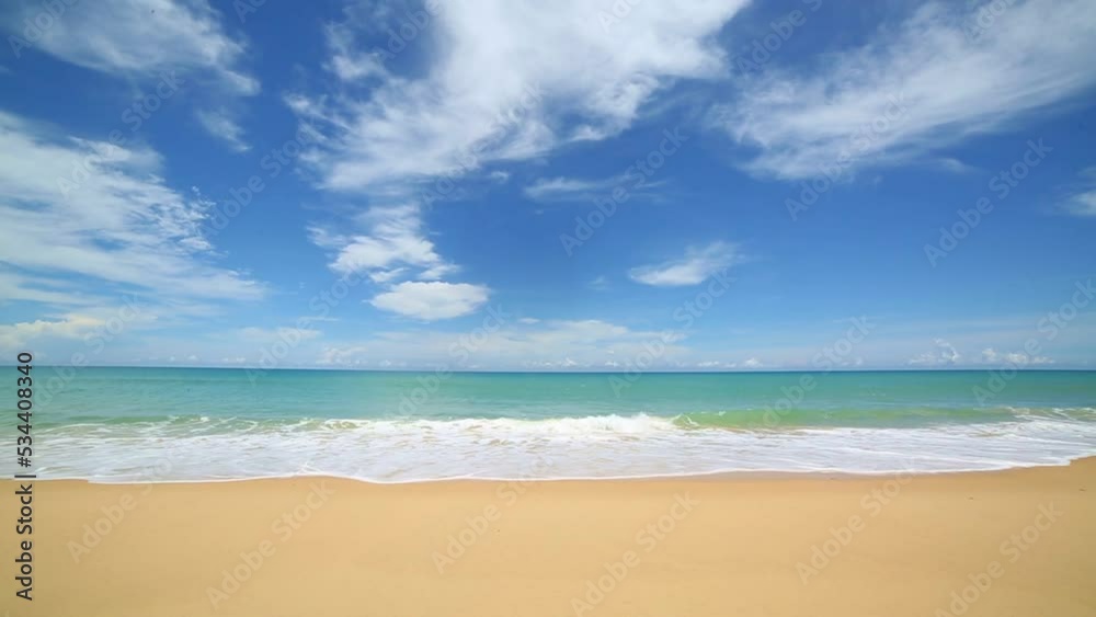 scenery smooth waves from green sea hit on the white long beach..beautiful nature on the beach..white cloud in blue sky background. scenery smooth waves from green sea hit on the white long beach..beautiful nature on the beach..white cloud in blue sky background.