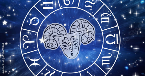 Image of aries star sign symbol in spinning horoscope wheel over glowing stars