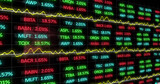 Digital image of stock market data processing against red digital wave on black background