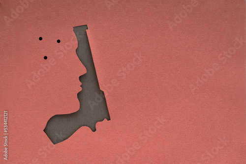Fotografie paper cut human face with gun silhouette texture background