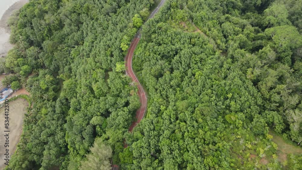 4K areal view of stunning mountain road through green forest. Meses Mountains. The best driving roads. Cars driving through the mountain roads 4K areal view of stunning mountain road through green forest. Meses Mountains. The best driving roads. Cars driving through the mountain roads