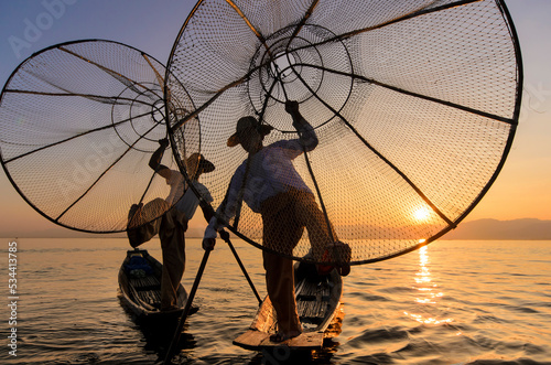 silhouette of a fisherman with a mini boat