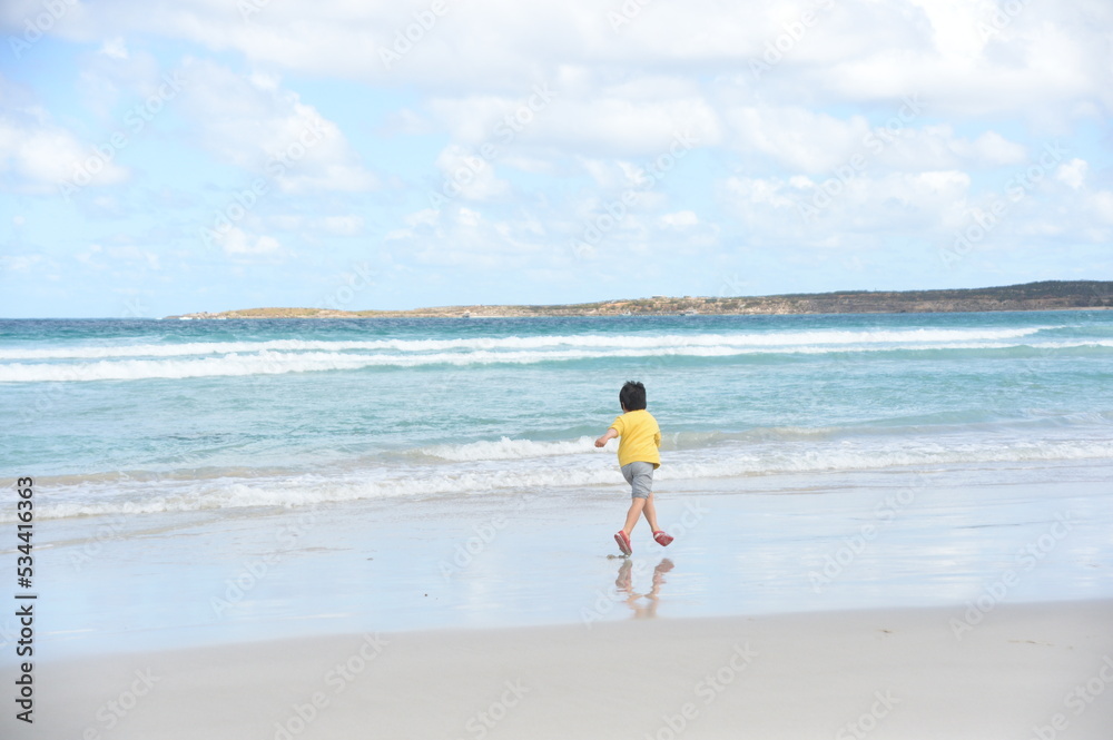 A boy going into the ocean
