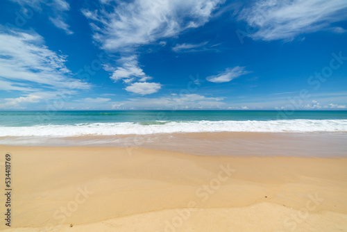 scenery white cloud in blue sky above long white beach..beautiful nature on the beach..smooth waves from green sea background.