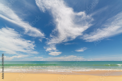Fototapeta Naklejka Na Ścianę i Meble -  scenery smooth waves from green sea hit on the white long beach..beautiful nature on the beach..white cloud in blue sky background..