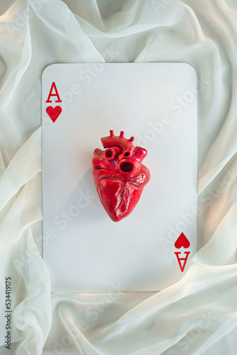 Ace of hearts, an anatomically correct heart in the center of a playing card photo