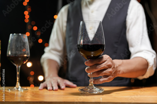 Bartender Serve wine, on wood bar, 