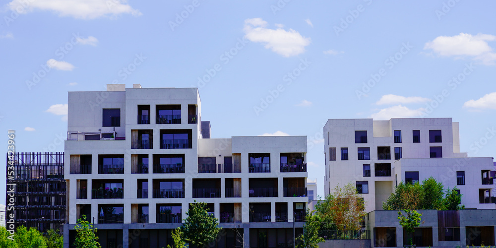 new modern white facade line building with balcony and terrace in blue sky