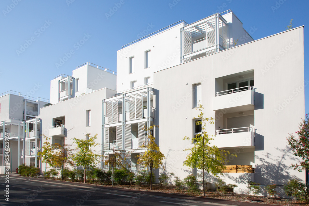 Modern residential white balcony building facade street view on blue sky