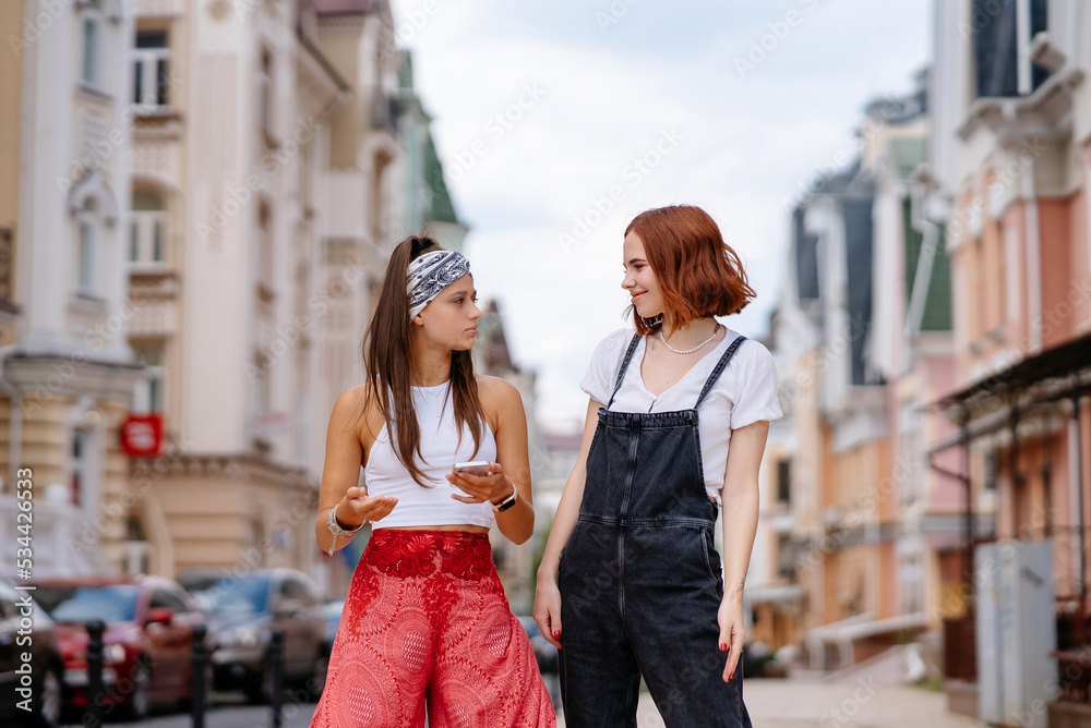 two young women walking outdoor having fun