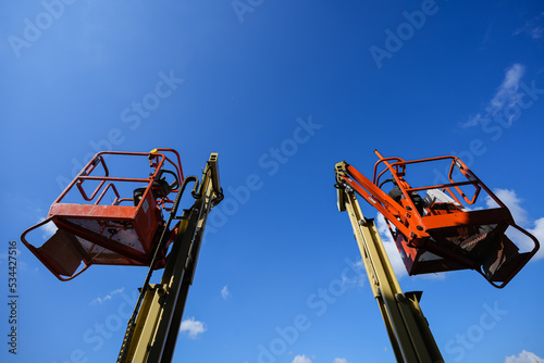 Wallpaper Mural Electric platforms for working at height for electricity power cables or construction industry photographed against blue sky. Torontodigital.ca