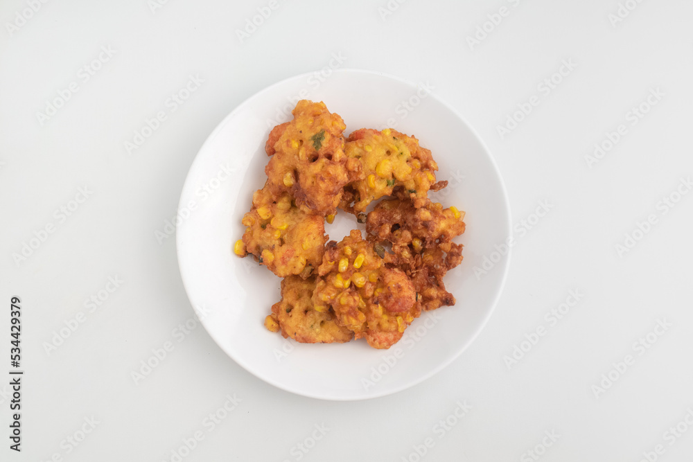 close up of fried corn fritter or in Indonesia called Perkedel Jagung or Bakwan Jagung with shrimp inside isolated on white background close up of fried corn fritter or in Indonesia called Perkedel Jagung or Bakwan Jagung with shrimp inside isolated on white background