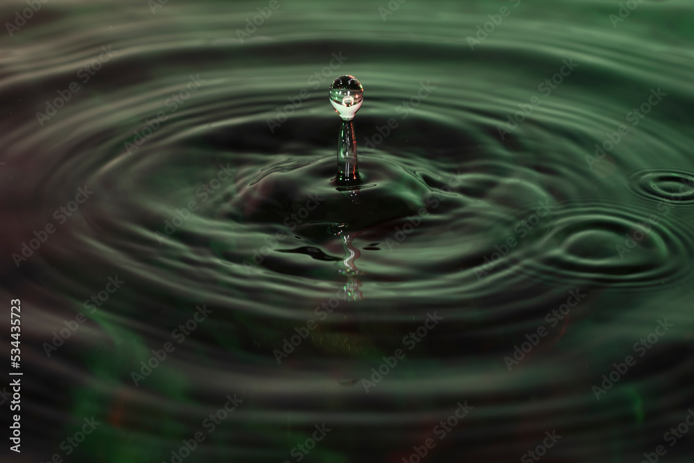 Green and red water dropping, water ripples in a pond. waves of rippling water. Green and red water dropping, water ripples in a pond. waves of rippling water.