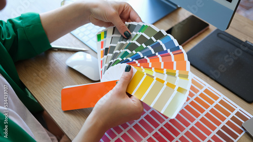 Designer shows color palette of samples of different colors and shades closeup